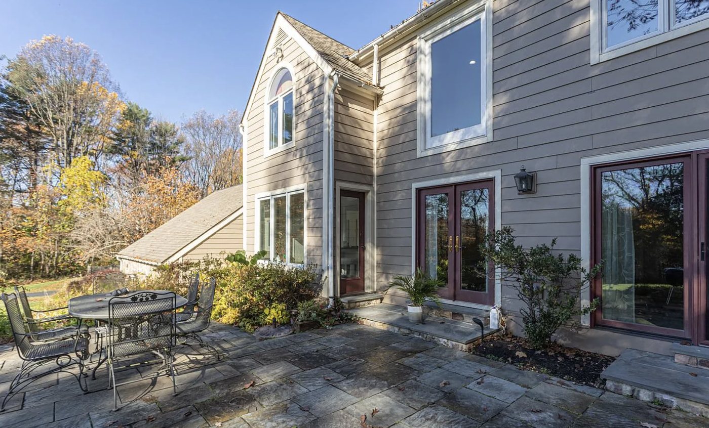 Sugan — a sided home with a flagstone patio and French doors